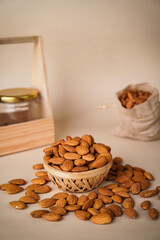 Badam [Almond] in Wooden Bowl In Cream Background