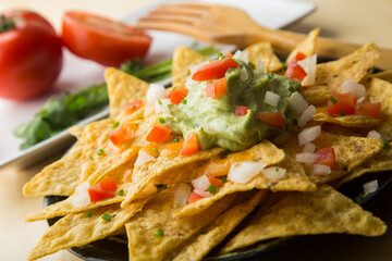 Nachos with guacamole. Nachos are a dish of Mexican origin, which consists of frying pieces of corn tortilla covered with a special cheese.