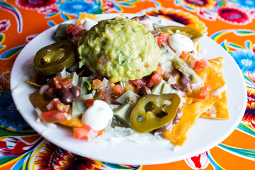 Nachos with guacamole. Nachos are a dish of Mexican origin, which consists of frying pieces of corn tortilla covered with a special cheese.
