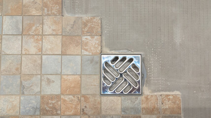 installation of new tiles on floor of Italian shower with evacuation of water diy tiling  work in...