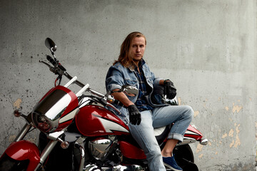 Obraz na płótnie Canvas Biker rides a motorcycle in an urban landscape.