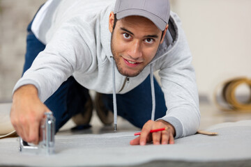 young man laying the floor panels