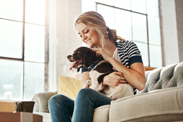 Woman, dog and calm smile on sofa in living room for animal care, love and support in home. Young...
