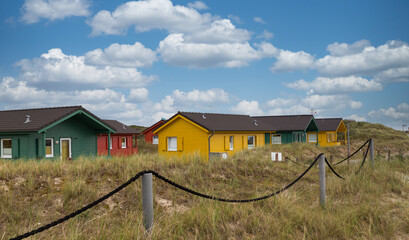 Fototapeta na wymiar Beautiful and colorful wooden houses on the beach of the island Heligoland - Dune.