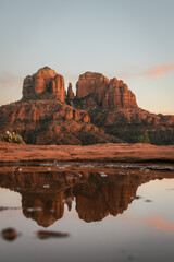 Reflection photo taken at sunset in Sedona Arizona United States Yavapai County at sunset in winter of Cathedral Rock illuminated with reds and oranges