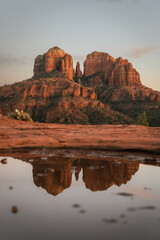 Reflection photo taken at sunset in Sedona Arizona United States Yavapai County at sunset in winter of Cathedral Rock illuminated with reds and oranges