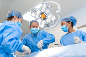 Surgery operation. Group of surgeons in operating room with surgery equipment. Medical background,...