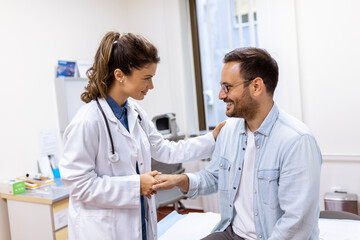 Smiling young female doctor shake hand close health insurance deal with elderly patient at consultation in hospital. Happy woman GP handshake greeting get acquainted with man in clinic. - Powered by Adobe