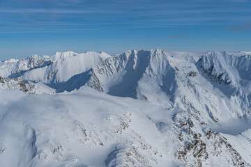 snow covered mountains,  viewpoint from Iezerul Caprei Peak, Fagaras Mountains, Romania 