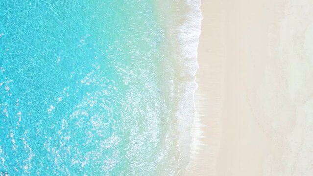 Tropical beach with white sand, turquoise ocean water, aerial view. Top view of paradise beach in tropics with clear sea