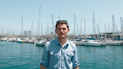 The guy in the blue shirt on the background of the yacht