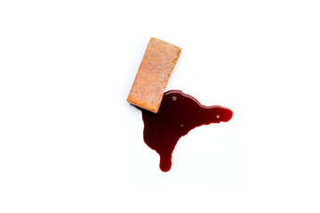Brick with blood on white background.
