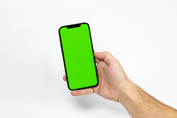 Green screen mobile phone in male hand white background