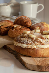 Roscon, Spanish sweet bread-based ring-shaped dessert, and variety of pastries on white table