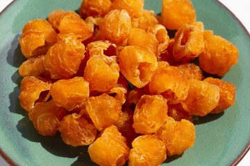 Dried longan on green plate