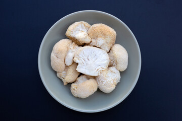 Fresh lion's mane mushroom on dark background.