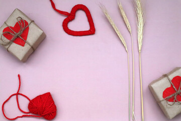 Craft gift box with red heart and craft ribbon on pink background. For celebrate. Valentines day conception.