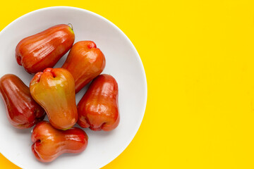 Fresh rose apple on yellow background.