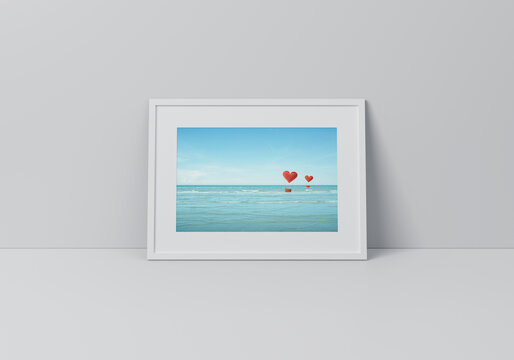 Red fabric heart love air balloon on tropical sea poster in horizontal white frame on floor over grey wall, Valentines day concept, 3D rendering