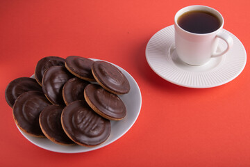 photo of a coffee mug and a plate full of chocolate chip cookies
