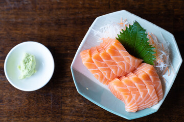Japan raw salmon slice or salmon sashimi in japanese style. Top view Salmon sasimi on disc.
