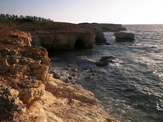 Water caves and rock formations close to Coral Bay on Cyprus Island. - obrazy, fototapety, plakaty