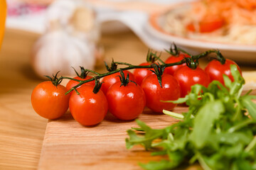 Sprig of cherry tomatoes on the table, close-up.