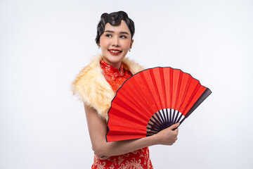 Beautiful Asian woman wearing cheongsam with fur cape holding red fan isolated on white background, Happy Chinese New Year.