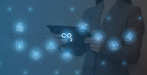 Businesswoman working virtual modern computer to reduce CO2 emissions carbon footprint climate...