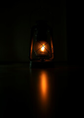 An old kerosene lamp is a light in the dark. There is no electricity