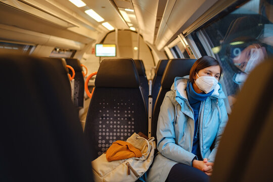 Asian Woman looking out of train window in winter day