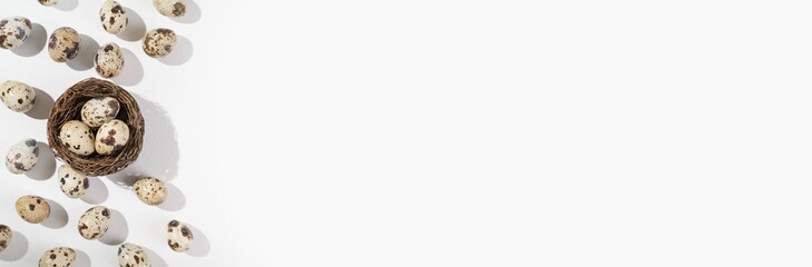 Fototapeta premium Quail eggs on a white background. Nest containing three egg. Minimal Easter concept. Natural farm products