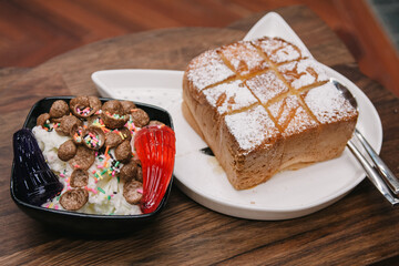 milk shaved ice decorated with jelly and chocolate cornflake served with vanilla bread toast