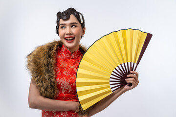 Beautiful Asian woman wearing cheongsam with fur cape holding gold fan isolated on white background, Happy Chinese New Year.