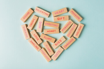 Wooden blocks with various words on the topic of Valentine's Day arranged in the form of a heart. Valentines day conceptual greeting