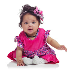 Cute, happy and portrait of a baby girl sitting isolated on a white background in a studio. Girly, playful and innocent, adorable and small child smiling with happiness on a studio background