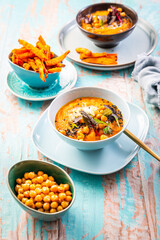 Carrot and sweet potato soup with chickpeas and fresh winter herbs