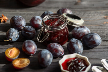 plum prune fruit jam with spices on a dark wooden background, the concept of preservation at home