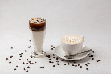 Side view on two drinks cappuccino and iced coffee