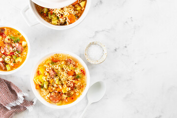 Smoked sausage minestrone tubetti pasta or orzo. Traditional Italian soup with pasta and seasonal vegetables.