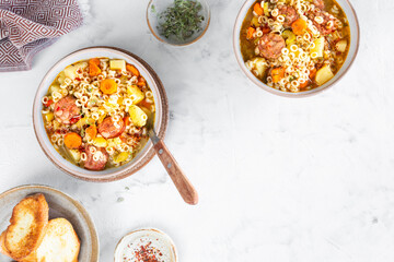 Smoked sausage minestrone tubetti pasta or orzo. Traditional Italian soup with pasta and seasonal vegetables.