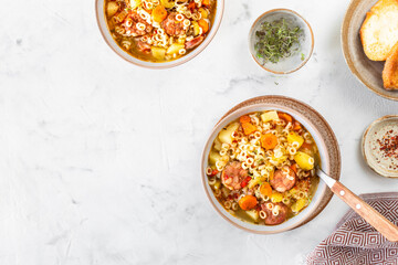Smoked sausage minestrone tubetti pasta or orzo. Traditional Italian soup with pasta and seasonal vegetables.