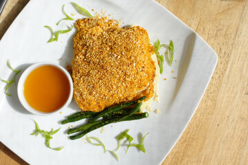 Fish fillet , lemon sauce on a plate on table 