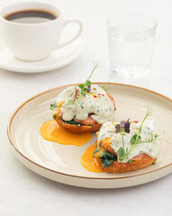 Side view on portion of benedikt egg with dor-blue sauce