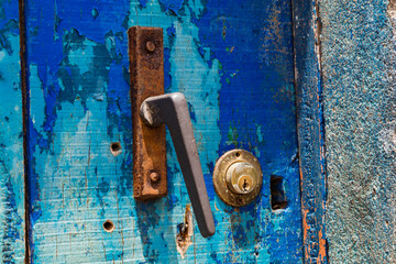 A blue wooden door with a lock and a rusty doorknob, Cape Verde