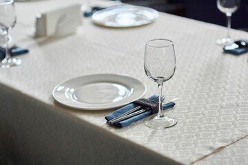 Crystal glasses for celebration, decorated for the holiday. Table setting.