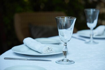 Crystal glasses for celebration, decorated for the holiday. Table setting.