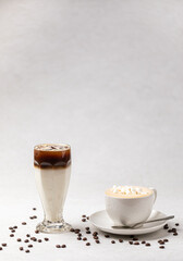 Side view on two drinks cappuccino and iced coffee