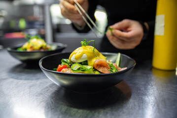 Chef in restaurant kitchen cooking salad