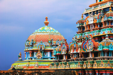 Beautiful view of colorful gopura and cupola in the Hindu Jambukeswarar Temple against the...